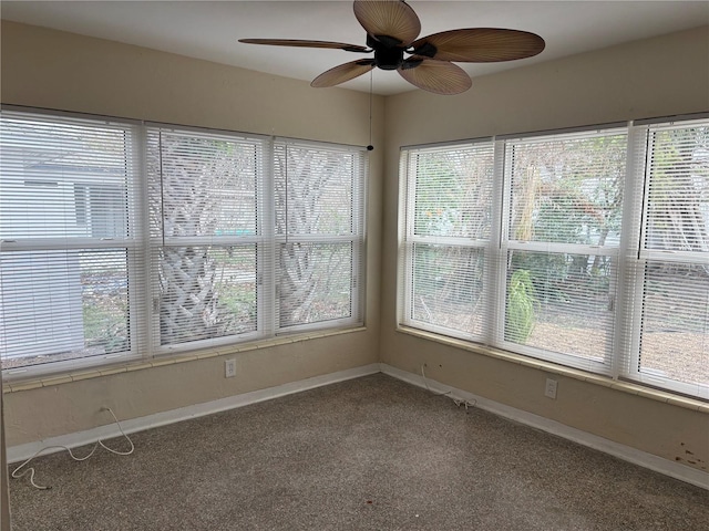 unfurnished sunroom with ceiling fan