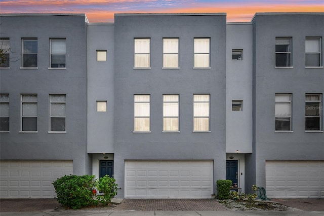 townhome / multi-family property featuring a garage