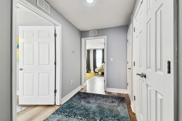 hall with light hardwood / wood-style floors