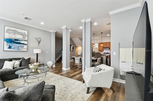 living room featuring dark hardwood / wood-style flooring and crown molding