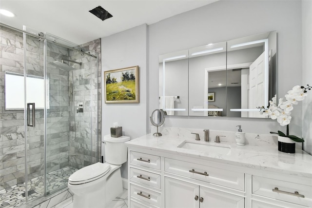 bathroom featuring vanity, toilet, and an enclosed shower