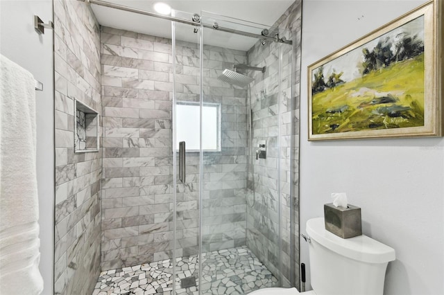 bathroom with walk in shower and toilet