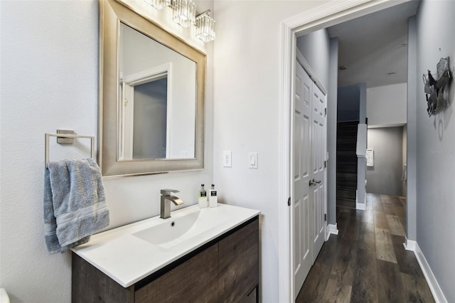 bathroom featuring a chandelier, vanity, and wood-type flooring