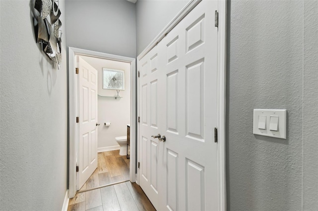 hall with light hardwood / wood-style floors