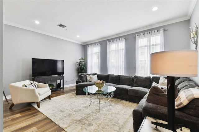 living room with hardwood / wood-style flooring and ornamental molding