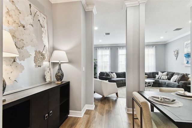 living room with hardwood / wood-style flooring and crown molding