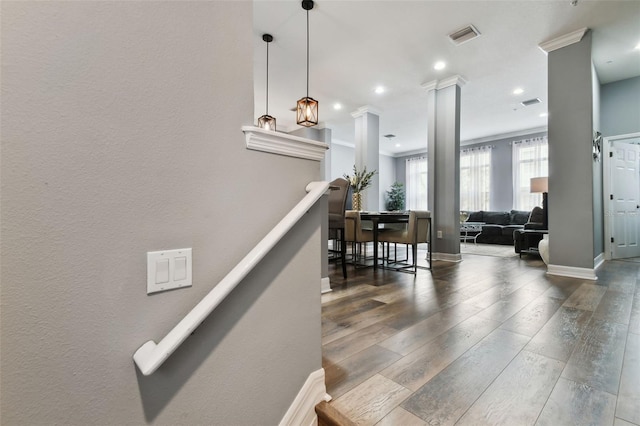 stairway with hardwood / wood-style flooring and ornamental molding