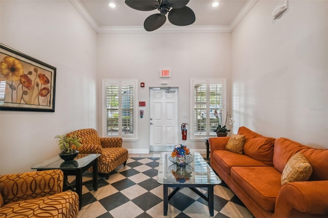 living room featuring a wealth of natural light, ceiling fan, a high ceiling, and ornamental molding