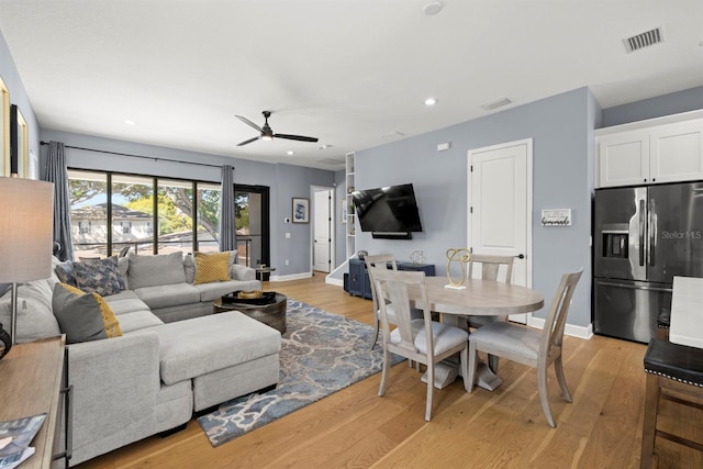 living room featuring light wood-type flooring and ceiling fan