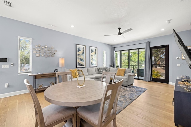 dining space with light hardwood / wood-style floors and ceiling fan