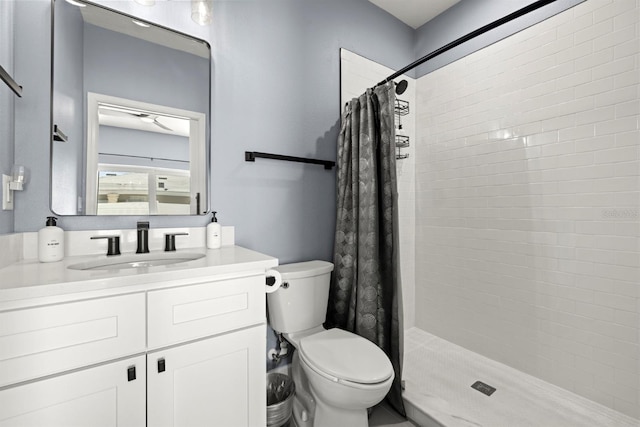 bathroom featuring curtained shower, vanity, and toilet