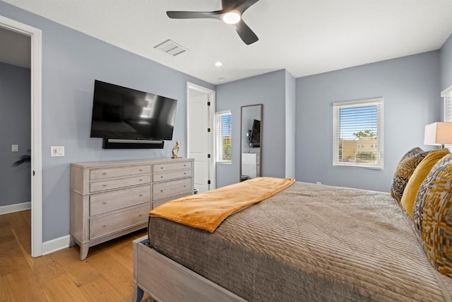 bedroom with light hardwood / wood-style floors and ceiling fan