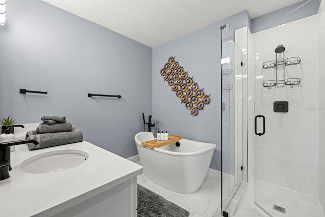 bathroom with vanity, a textured ceiling, and separate shower and tub