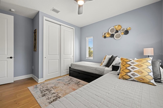 bedroom featuring a closet, light wood-type flooring, and ceiling fan