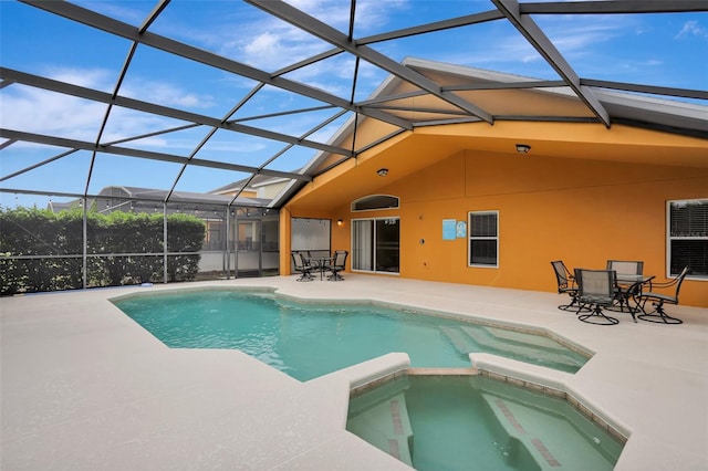 view of pool featuring outdoor dining space, a patio area, glass enclosure, and a pool with connected hot tub