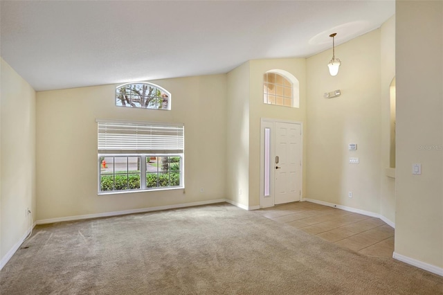 entryway featuring light carpet and high vaulted ceiling