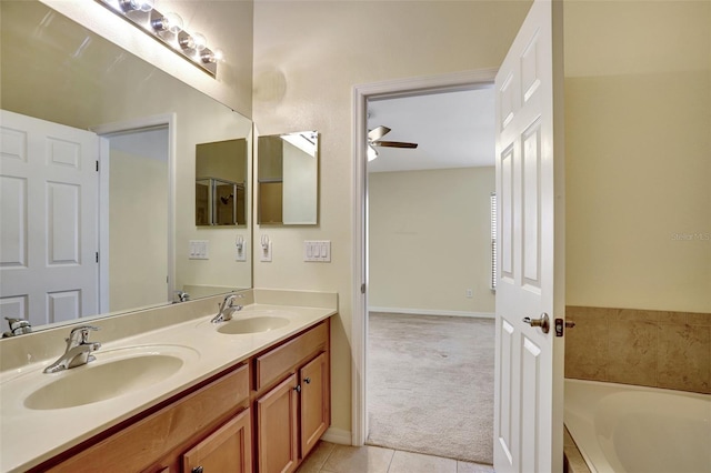 bathroom featuring a bathtub, vanity, tile patterned floors, and ceiling fan