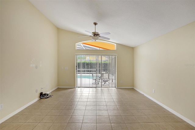 unfurnished room with a ceiling fan, light tile patterned flooring, vaulted ceiling, and baseboards