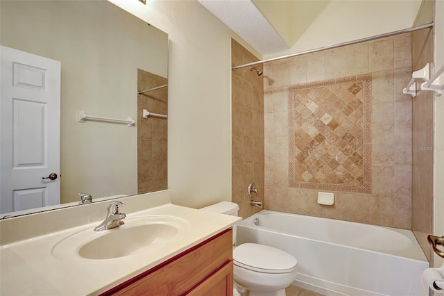 full bathroom featuring vanity, tiled shower / bath combo, and toilet