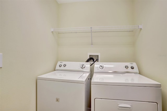 washroom with washing machine and clothes dryer