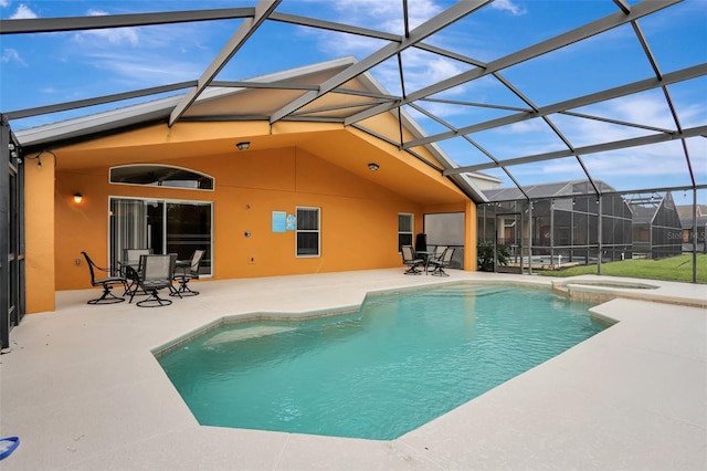 view of pool with a lanai, a patio area, and a pool with connected hot tub