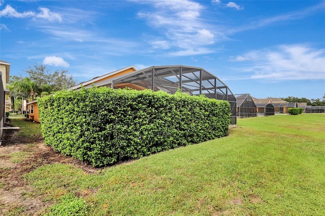 view of yard with a residential view and glass enclosure