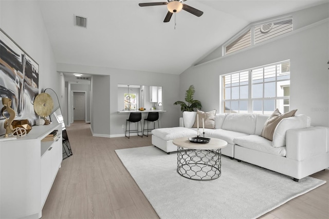 living room featuring light hardwood / wood-style floors, ceiling fan, and lofted ceiling