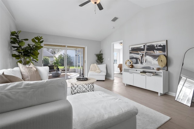 living room with lofted ceiling, hardwood / wood-style flooring, and ceiling fan