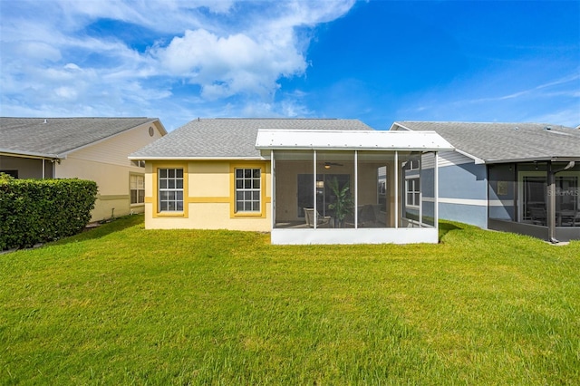 back of house with a lawn and a sunroom