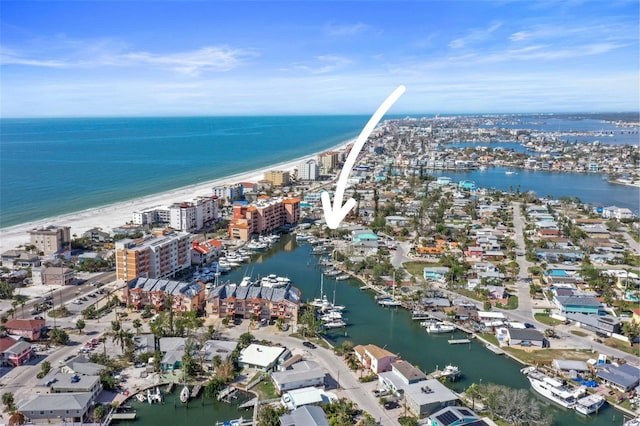 birds eye view of property featuring a beach view and a water view