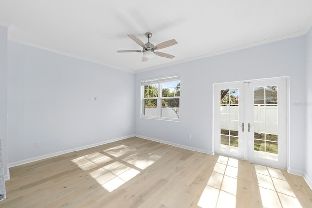 empty room featuring ceiling fan, light hardwood / wood-style floors, crown molding, and french doors