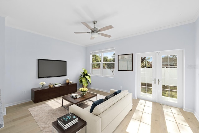 living room with french doors, light hardwood / wood-style flooring, ceiling fan, and ornamental molding