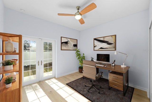 home office with ceiling fan, light hardwood / wood-style floors, and french doors