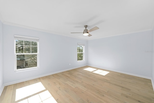 empty room with ceiling fan, crown molding, and light hardwood / wood-style flooring