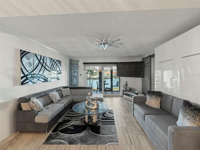 living room with a textured ceiling, light wood-type flooring, and crown molding