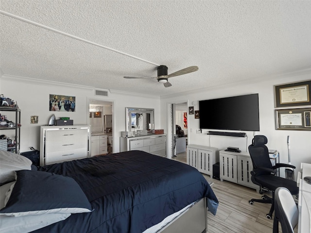 bedroom featuring ensuite bathroom, ceiling fan, a textured ceiling, and light hardwood / wood-style flooring