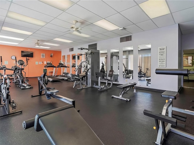 workout area featuring a paneled ceiling and ceiling fan