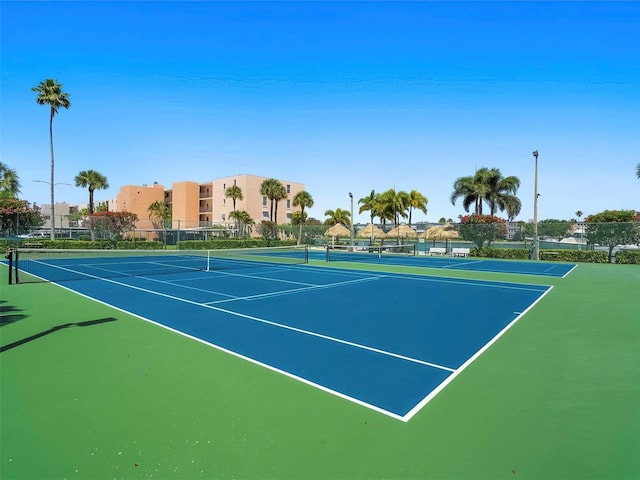 view of tennis court with basketball hoop