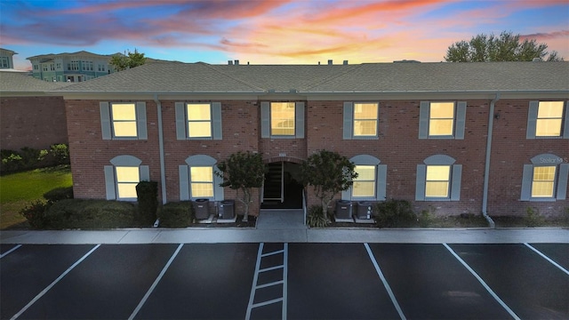 outdoor building at dusk featuring central AC unit