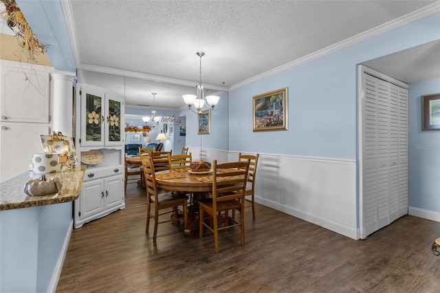 dining room featuring dark hardwood / wood-style flooring, a textured ceiling, and crown molding