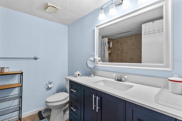 bathroom with tile patterned floors, toilet, a textured ceiling, a tile shower, and vanity