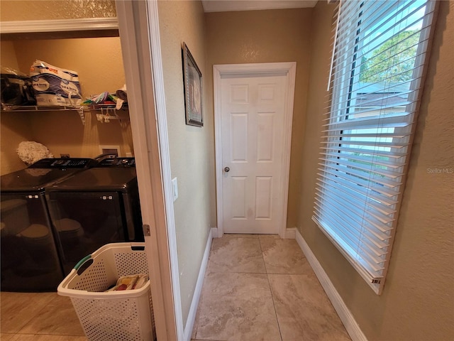 washroom with independent washer and dryer and light tile patterned floors