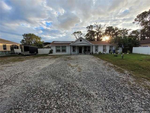 single story home featuring a front lawn and a porch