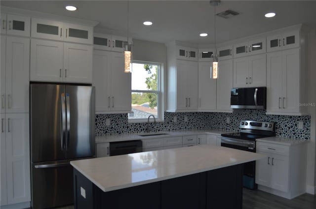 kitchen featuring a sink, visible vents, light countertops, appliances with stainless steel finishes, and a center island