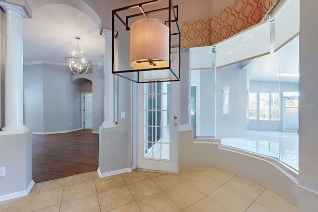 interior space with ornate columns and crown molding