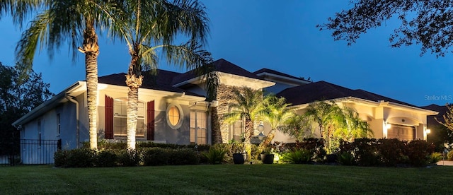 view of front of property featuring a garage and a front yard