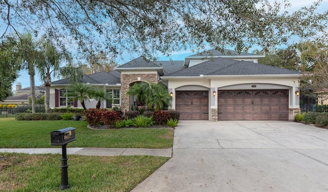 view of front of home featuring a garage and a front lawn