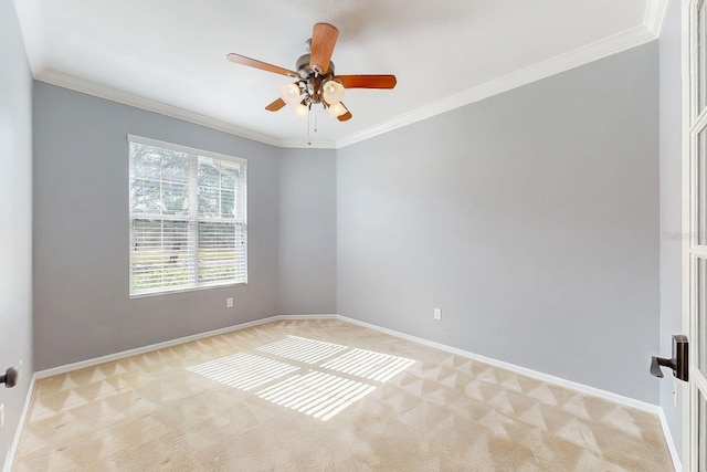 carpeted empty room with ceiling fan and ornamental molding