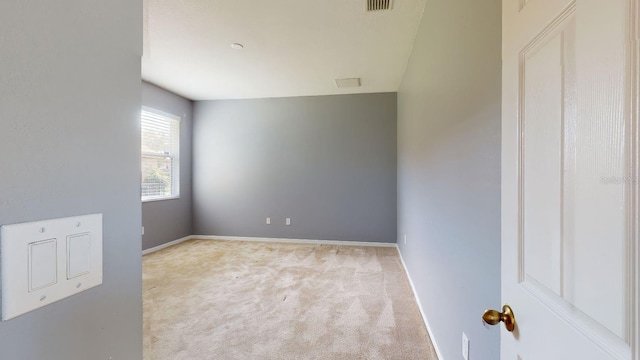 unfurnished room with light carpet