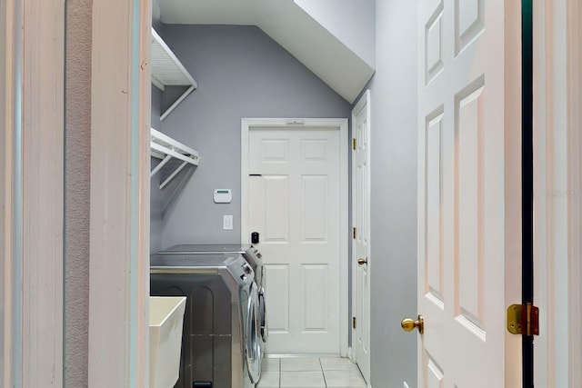 laundry room with light tile patterned flooring, sink, and independent washer and dryer